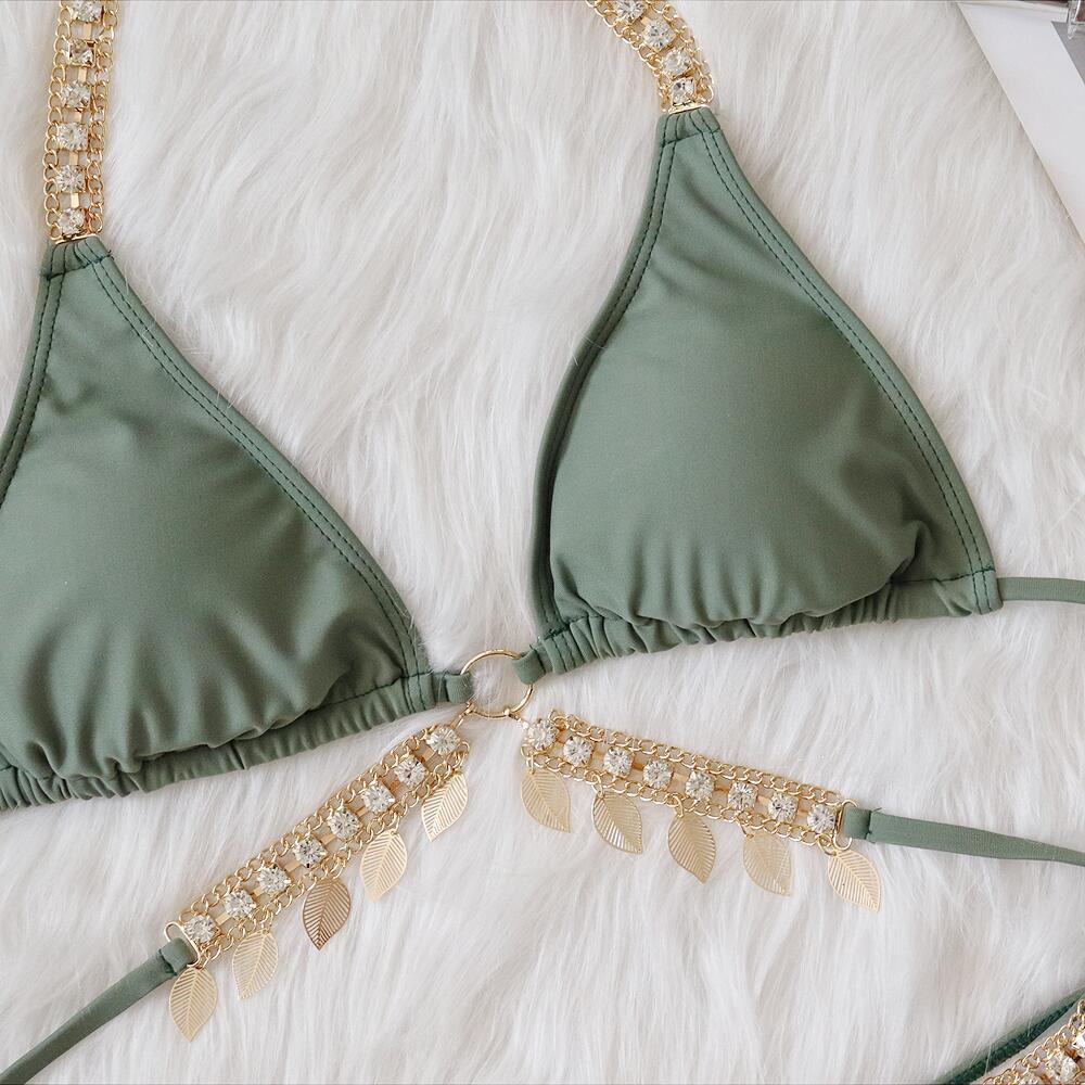 Chain straps gather the split swimsuit