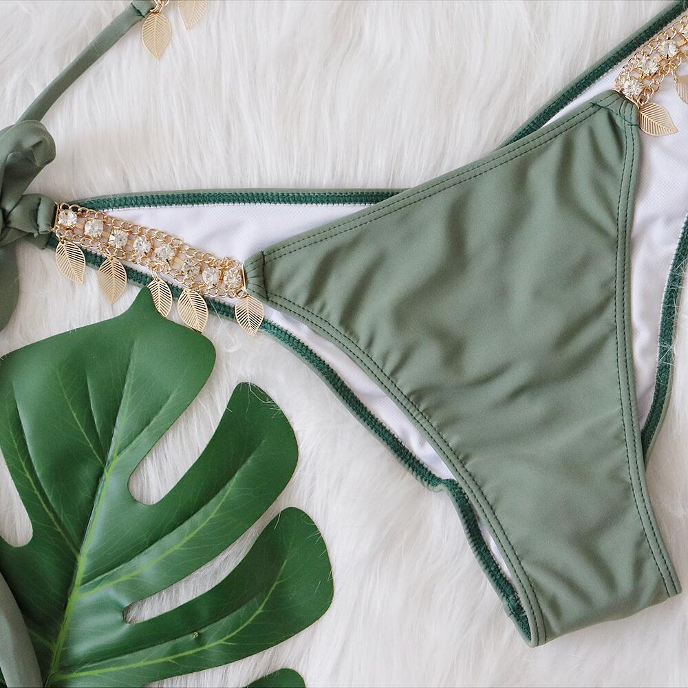Chain straps gather the split swimsuit