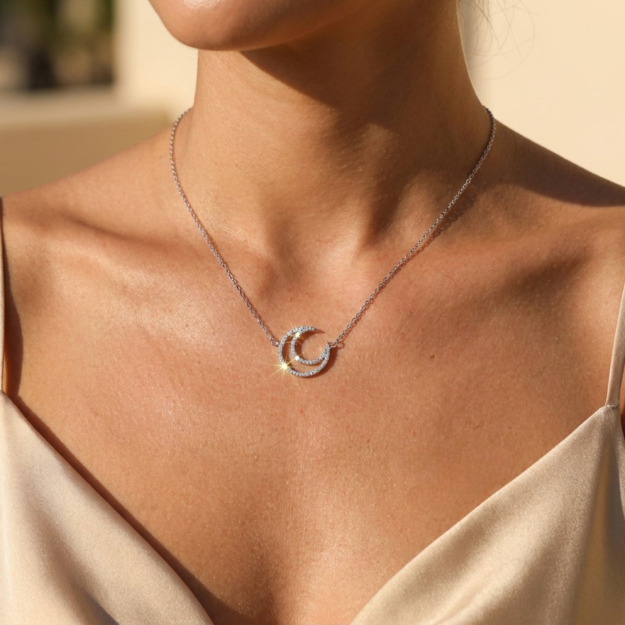 Woman wearing 925 sterling silver crescent moon pendant necklace with zirconia stones